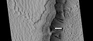 Layers in Gordii Dorsum Region, as seen by HiRISE under HiWish program. Dark lines are Dark Slope Streaks.