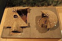 Two models of neolithic houses in a museum