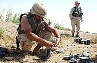 U.S. Army soldier with various PMN-1 mines near Fallujah, Iraq.