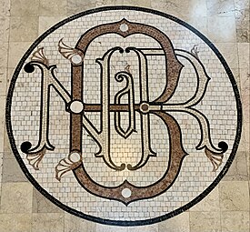 Beaux-Arts monogram of the National Bank of Romania in the BNR Building, Bucharest, Romania, designed by Paul Louis Albert Galeron, Grigore Cerchez or Constantin Băicoianu, 1883-1900