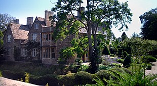 Large Elizabethan manor house in formal gardens