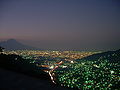 San Salvador volcano towering over San Salvador city at night