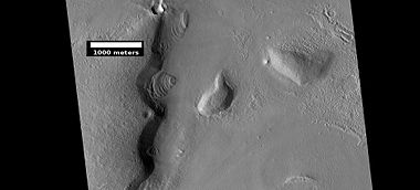 Layered features, as seen by HiRISE under HiWish program. On the right side of picture a small region of ribbed upper plains material is changing into brain terrain.