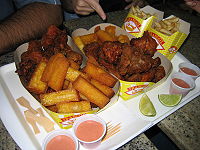 Fried polenta, French fries, and fried chicken at a Brazilian eatery