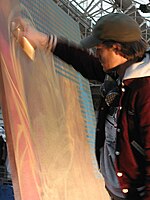 A graffiti artist working with spray paint at a Graffiti competition in London