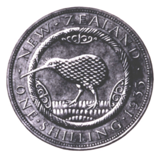 A plaster model of a design for the New Zealand shilling. An abstract kiwi, feathers textured in a rippled effect, is facing left. To the left, right, and above the bird are abstract wood-carving designs. Textured grass, consisting of many small ovals, is below the bird. Surrounding the kiwi is a rope-like circle, bordered by the text "NEW ZEALAND, ONE SHILLING, 1933"