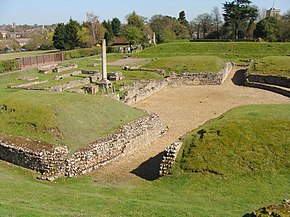 Roman theatre packed-earth entryway and central stage surrounded by grass-covered seating hillocks (ruins)