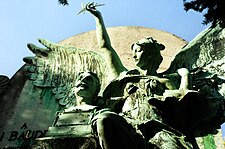 Part of composition on tomb of Paul Baudry. A winged angel is about to place a crown of laurels on Baudry's head.