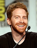 A young man with red hair smiling