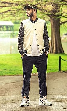 American producer Swizz Beatz standing in a park