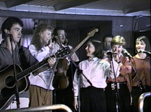 The Rankin Family performing aboard the M/S Scotia Prince, April 18, 1990. From left to right: Jimmy Rankin, guest Natalie MacMaster, guest Bruce Phillips, Raylene Rankin, John Morris Rankin, Cookie Rankin, Heather Rankin.