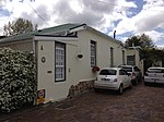 Terraced single storey vernacular coattages opening onto sidewalk; full hipped corrugated iron roof with projecting eaves over front facades; various modern stock doors, windows, and louvred shutters, unpainted joinery to no 1.27; high boundary wall to Type of site: House Current use: House. The historic Old Wynberg Village is an area of considerable character, as well as being of historical, architectural and environmental importance. It is one of the few areas close to the City of Cape Town that have retained their historical character.