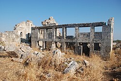 Villa in Barisha with porch pillars. To the left is the east gable of a basilica.