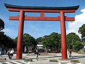 A red torii at the entrance of a Shinto shrine