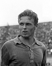 A black and white photograph of a footballer