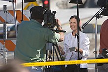 waist high portrait of a TV cameraman and reporter