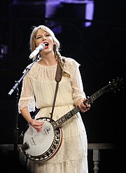 Taylor Swift on the Speak Now tour, dressed in white