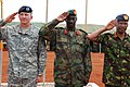 Maj. Gen. William B. Garrett III, commander of U.S. Army Africa, Gen. Nyakayirima Aronda, Chief of Defense Forces, Ugandan People’s Defense Force, and Gen. Jeremiah Kianga, Chief of General Staff, Kenya, render honors during the opening ceremony for Natural Fire 10, Kitgum, Uganda, Oct. 16, 2009.