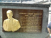 A plaque commemorating "Edward Grant Barrow" attached to a marble wall