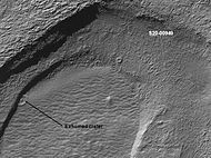 Crater that was buried in another age and is now being exposed by erosion, as seen by the Mars Global Surveyor. This is evidence that there may be many buried craters in the subsurface of Mars.