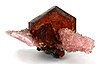 Hexagonal crystal of reddish-brown shigaite with pink rhodochrosite
