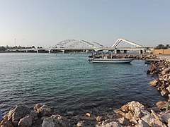 The Maqta' Bridge (Arabic: جِسْر ٱلْمَقْطَع, romanized: Jisr Al-Maqṭaʿ; front) and Sheikh Zayed Bridge (Arabic: جِسْر ٱلشَّيْخ زَايِد, romanized: Jisr Ash-Shaykh Zāyid; back) at Al-Maqṭaʿ (Arabic: ٱلْمَقْطَع), which connects the island of Abu Dhabi to the mainland