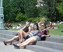 Women in casuals relaxing at a park in USA, 2010