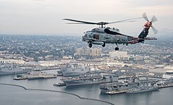 An MH-60R Sea Hawk helicopter flies over Naval Base San Diego during 2017