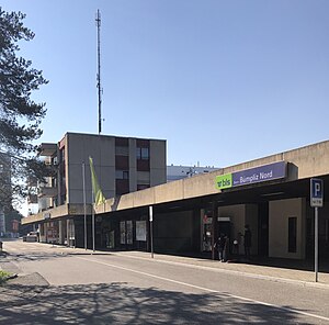 Four-story building next to a kiosk