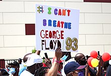 Protester holding up a sign reading # I can't breathe George Floyd '93