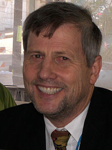 Head shot of Mr Marlantes wearing jacket and necktie. There is some greying of the temples, and he seems unshaven.