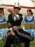 A Kyrgyz Manaschi wears a white kalpak for a special occasion