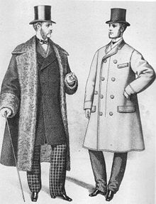 Black-and-white fashion plate of two Victorian-era white men each wearing top hats, coats, trousers and black shoes. The man on the left is wearing an open, thick overcoat that reaches to his calves, with loose sleeves that reach his wrists and wide cuffs on the sleeves. The lapel is also broad, covering his shoulders. He is wearing a coat beneath this that reaches his knees that fastens off-center. Beneath that, a pair of checked trousers is visible on the lower-half and upper-half a vest is visible over a white shirt with a tall collar and small bowtie. The man on the right is wearing a buttoned topcoat that reaches his knees where it flares out. His sleeves reach his wrists and the coat is buttoned off-center with two rows of buttons. Beneath this are a pair of dark trousers and a barely visible neckline of a white shirt.