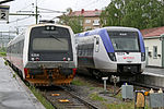 Swedish Veolia Transport Regina built by AdTranz and a Norwegian BM92 built by Duewag on Mittnabotoget at the Station of Östersund