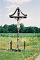 A Latin crucifix with a stylized INRI plaque attached, in cornfields near Mureck Styria, Austria