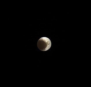 One of Cassini's final images of Iapetus taken on May 30, 2017, a few months before Cassini plunge into Saturn, at a distance of 2.5 million kilometers (1.6 million miles). The clearly-visible craters right of center on the white side are Naimon, Astor and Ivon (left to right).