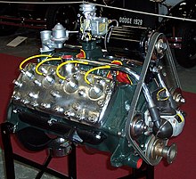 Ford flathead V8 engine from the 1930s on an engine stand, slightly modernized with chrome.