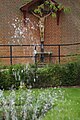 A crucifix overlooks a fountain at the Anglican Shrine of Our Lady of Walsingham