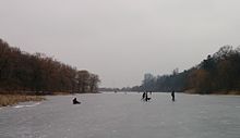 several people wearing skates on frozen pond