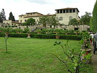 A decaying Tuscan villa stands against a clear-sky.