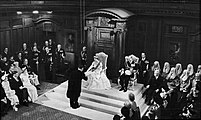 The Queen opening a session of the New Zealand Parliament on 12 January 1954 in the Legislative Council Chamber, Parliament House. She is wearing her coronation gown.
