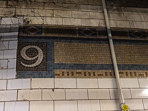 Original mosaic trim remnant in the southbound fare area