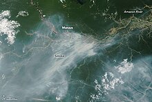 Smoke streaming from fires burning near Manaus, capital city of Brazil's Amazonas state, on October 11, 2023