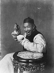 In the late 19th century and early 20th century, photographs taken in the United Kingdom rarely depicted people smiling, in accordance with the cultural conventions of Victorian and Edwardian society. In contrast, the photograph Eating Rice, China depicts a smiling Chinese man.[19]