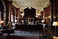 The classical style bar in the dining room, National Liberal Club, London (1884–87), an example of Waterhouse's furnishings, made of solid mahogany, note the geometrical patterns of the ribs in the plasterwork ceiling and the pendant light fittings