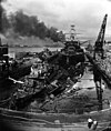 USS Pennsylvania (BB-38) lead ship of the Pennsylvania-class battleship, behind two wrecked destroyers in Drydock One at the Pearl Harbor Navy Yard, soon after the end of the Japanese air attack