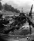 USS Pennsylvania (BB-38) lead ship of the Pennsylvania-class battleship, behind two wrecked destroyers in Drydock One at the Pearl Harbor Navy Yard, soon after the end of the Japanese air attack