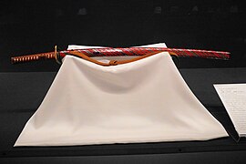A hirumaki (leech patterned) katana mounting coated with vermilion lacquer and wrapped in a thin silver plate, Edo period, The Japanese Sword Museum