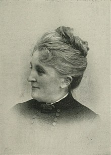 B&W portrait photo of a woman with her hair in an up-do.