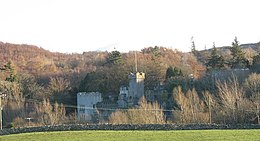 View across fields to castle on a ridge.